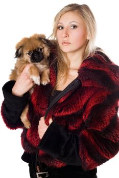 Attractive young woman holding a pekinese puppy. Isolated on white