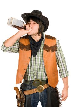 Cowboy drinking whiskey from the bottle. Isolated