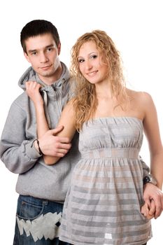 Young nice cheerful couple posing. Isolated on white