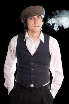 Young man thrusting hands into his pockets and smoking