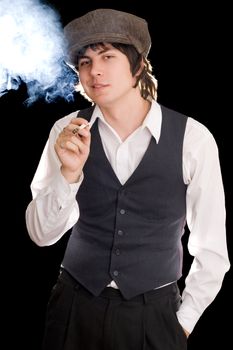 Young man smoking and making faces. Isolated on black