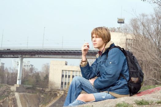 The sitting guy with a cigarette outdoor 2