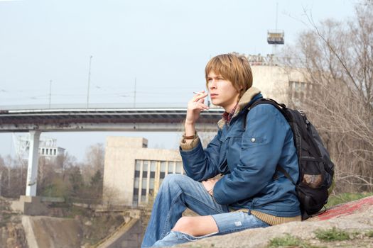 The sitting guy with a cigarette outdoor 1