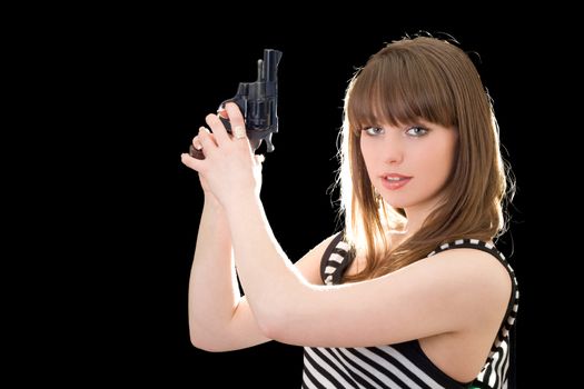 Beautiful young woman with pistol. Isolated on black