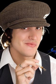 Portrait of young man holding cigarette and making faces