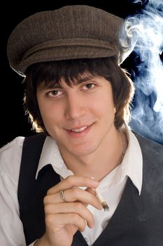 Portrait of cheerful man with a cigarette. Isolated on black