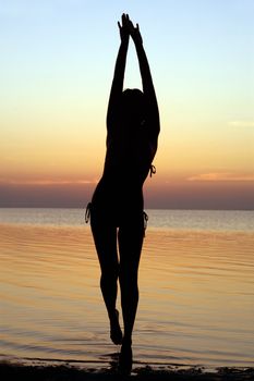 Silhouette of a girl standing in water