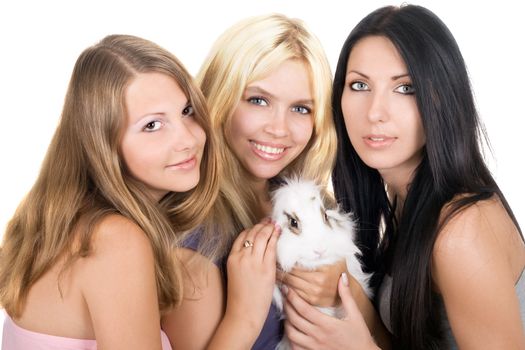 Portrait of three women with a rabbit. Isolated on white