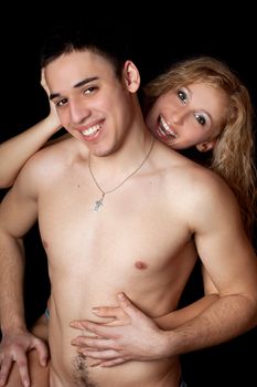 Portrait of joyful young couple. Isolated on black background