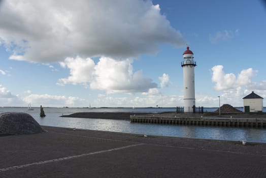 sailing boats on the lake called haringvliet  in Holland with the lighthouse in front