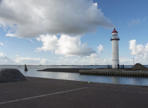 sailing boats on the lake called haringvliet  in Holland with the lighthouse in front