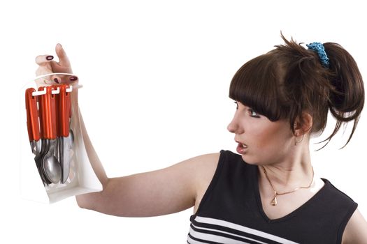 The mad housewife with knifes, spoons, plugs. funny picture