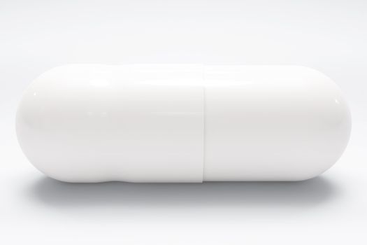 White medical pill on white background, with shadow, closeup