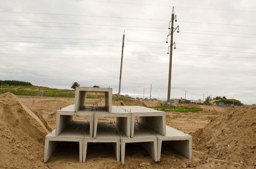 material used in road construction works. concrete block mold between sand piles.