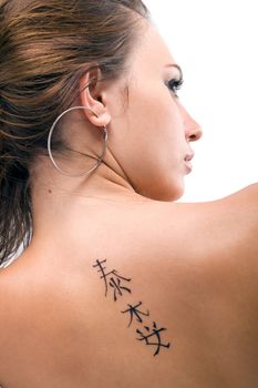 Tattoo on a back of the young woman. Isolated 3