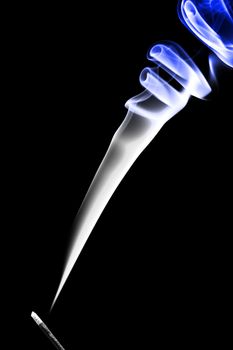 Stick with a blue smoke. Isolated on a black background