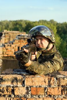 Soldier with a machine gun in camouflage uniform