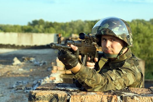Portrait of soldier in camouflage with machine gun
