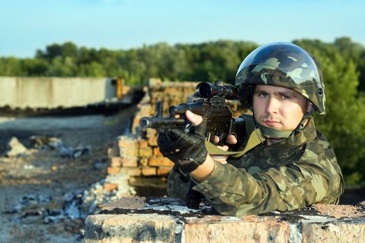 Sniper in camouflage uniform with machine gun