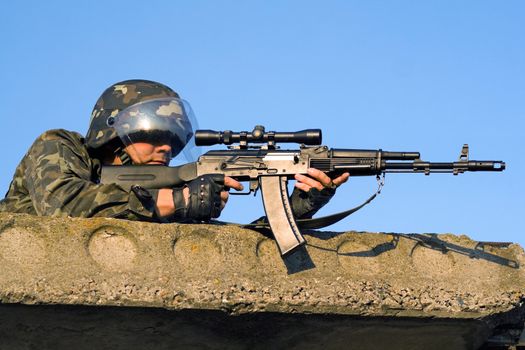 Sniper with machine gun waiting in ambush