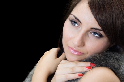 Portrait of young pretty brunette. Isolated on black