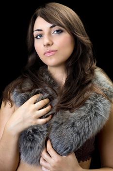 Portrait of attractive thoughtful brunette. Isolated on black