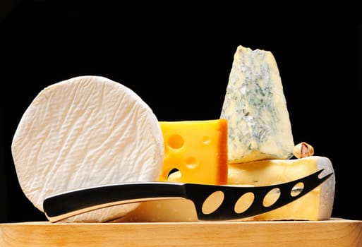 Various types of cheese over black 
