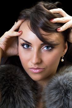Close-up of seductive brunette. Isolated on black