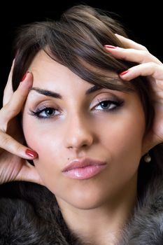 Portrait of likeable young woman. Isolated on black