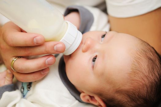 Dad feeding his newborn baby
