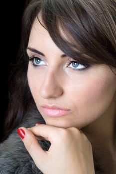 Portrait of thoughtful pretty woman. Isolated on black