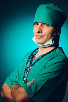 Surgeon with stethoscope over blue background