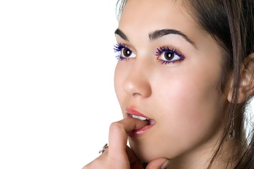 Portrait of young woman with a finger in her mouth