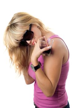 Playful sexy blonde with a glass of drink. Isolated on white