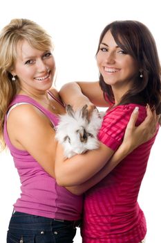 Two young women playing with little rabbit. Isolated