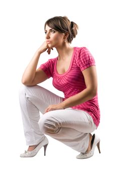 Thoughtful pretty woman in the squatting position. Isolated