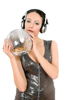 Beautiful young woman in headphones with a mirror ball. Isolated