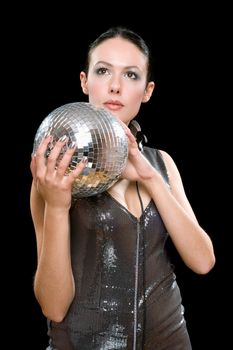 Portrait of young brunette with a mirror ball in her hands. Isolated on black