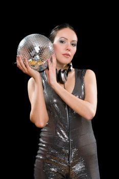 Portrait of nice young brunette with a mirror ball in her hands. Isolated on black