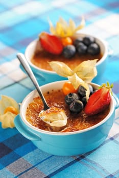 Creme brulee (cream brulee, burnt cream) with fruits and berries