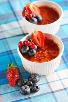 Creme brulee (cream brulee, burnt cream) with fruits and berries