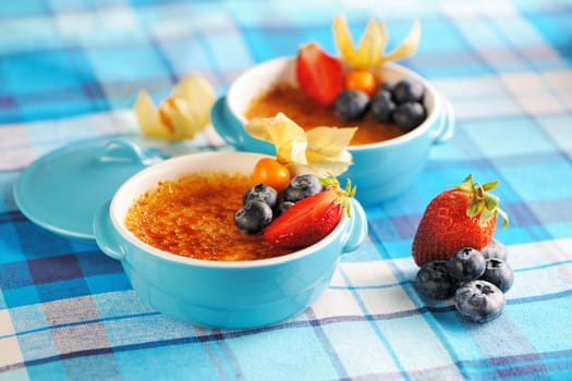 Creme brulee (cream brulee, burnt cream) with fruits and berries