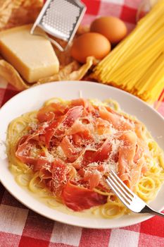 Pasta carbonara over red cloth