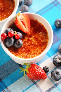 Creme brulee (cream brulee, burnt cream) with fruits and berries