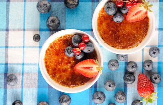 Creme brulee (cream brulee, burnt cream) with fruits and berries