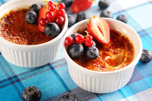 Creme brulee (cream brulee, burnt cream) with fruits and berries