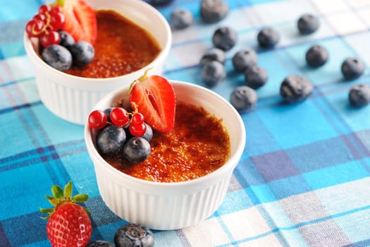 Creme brulee (cream brulee, burnt cream) with fruits and berries
