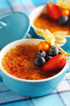 Creme brulee (cream brulee, burnt cream) with fruits and berries