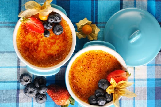 Creme brulee (cream brulee, burnt cream) with fruits and berries