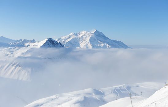 Mountains in clouds with snow in winter, Val-d'Isere, Alps, France